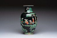 An unusual Chinese famille noire vase with relief design, Kangxi mark, 19th C.