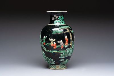An unusual Chinese famille noire vase with relief design, Kangxi mark, 19th C.