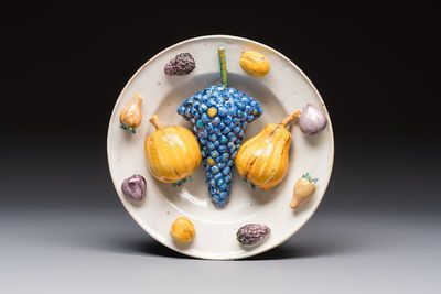 An unusual polychrome Swiss faience trompe l'oeil dish with various fruits, Winterthur, workshop of David Pfau II, 17th C.