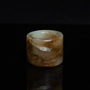 Een Chinese boogschuttersring in gevlekte celadon jade, Ming — foto 1