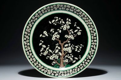 Een Chinese famille noire op biscuit schotel met prunusboom, Kangxi
