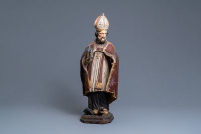 Een grote gepolychromeerde houten figuur van Sint-Amand, 17e eeuw