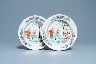 Een paar Chinese famille rose borden met figuren in een tuin, Yongzheng/Qianlong