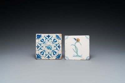 Een polychrome Delftse tegel met een slak op een plant en een blauw-witte met een slak in een ornament, 17e eeuw
