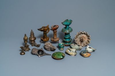 Fifteen islamic bronze and pottery oil lamps, 16th C. and later