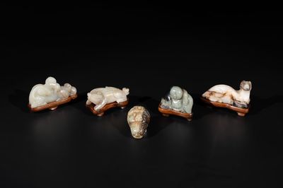 Five Chinese jade carvings with four wooden stands, 19th C.