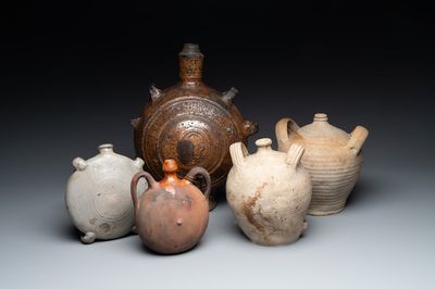 Five stoneware jugs or pilgrim flasks, including a Raeren example with armorial design, 16/17th C. and later