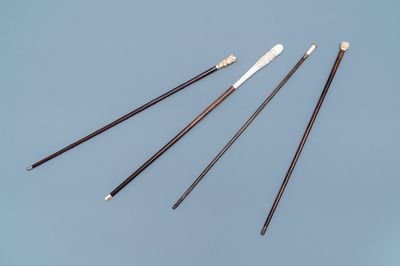 Four Asian coral and ivory-handled canes, 19th C.