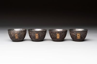 Four Chinese carved and silver-lined coconut cups, 19/20th C.