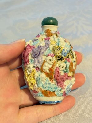 Four Chinese famille rose moulded 'Luohan' snuff bottles, Qianlong marks, 19th C. — photo 24