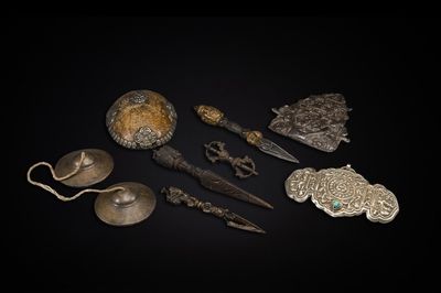 Four Tibetan bronze and wooden phurbas, a 'kapala' or skull-bowl, a pair of brass tingsha and two silver ornaments, 19th C.