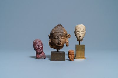Four various carved stone heads, 17th C. and later