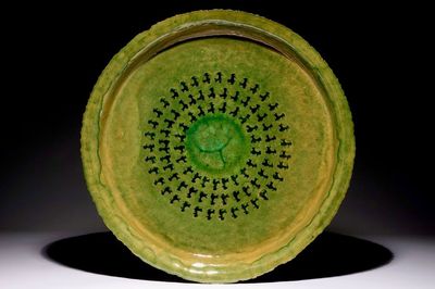 Jack Jefferys (1896-1961): A large decorated green glazed ceramic dish