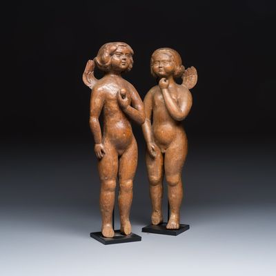A pair of carved wooden figures of winged angels, probably 17th C.