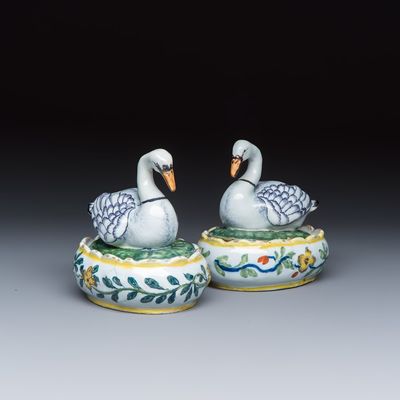 A pair of polychrome Dutch Delft butter tubs and covers in the shape of swans, 18th C.