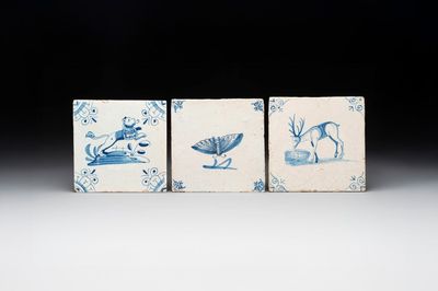 Three blue and white Dutch Delft tiles with a lion, a butterfly and a deer, 17th C.