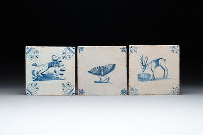Three blue and white Dutch Delft tiles with a lion, a butterfly and a deer, 17th C.
