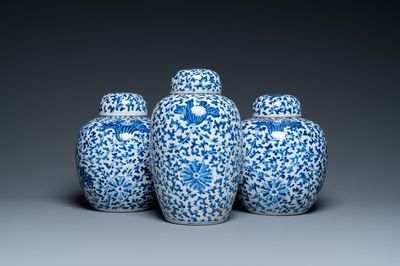 Three Chinese blue and white jars and covers with floral scrolls, 19th C.