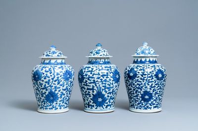 Three Chinese blue and white 'lotus scroll' vases and covers, Transitional period/Kangxi