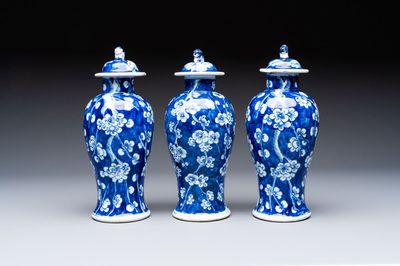 Three Chinese blue and white 'plum blossom' vases and covers, Kangxi mark, 19th C.