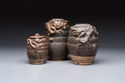 Three Chinese brown-glazed jars with an applied dragon design, one with cover, Song