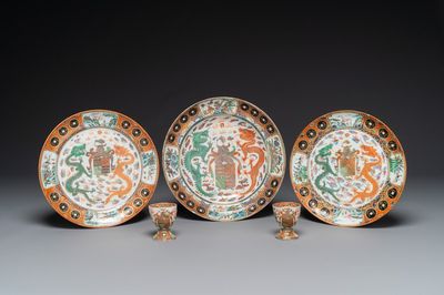 Three Chinese Canton famille rose armorial plates and a pair of egg cups for the Portugese market, Guangxu