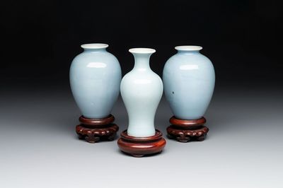 Three Chinese claire-de-lune vases on wooden stands, Kangxi mark, 19th C.