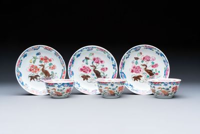Three Chinese famille rose cups and saucers with a duck among flowering branches, Yongzheng/Qianlong