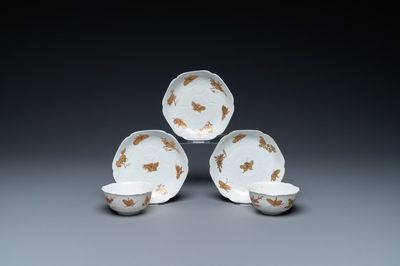 Three Chinese iron-red and gilt 'butterfly' saucers and two cups, Yongzheng