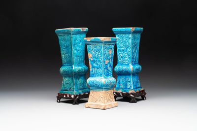 Three Chinese turquoise-glazed 'gu' vases with floral design, two with wooden stands, Ming