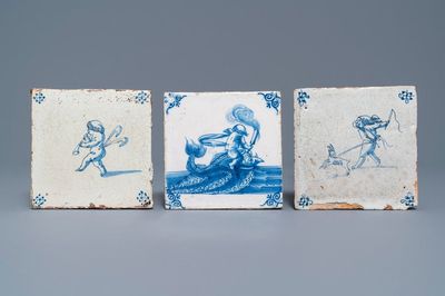 Three Dutch Delft blue and white putti and seacreature tiles, 17th C.