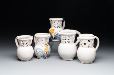 Three French white-glazed and two polychrome puzzle jugs, Nevers, 18th C.
