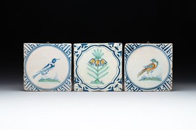 Three polychrome Dutch Delft 'flower' and 'bird' tiles, 17th C.