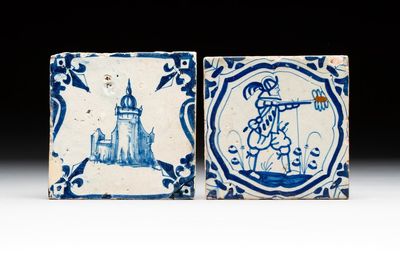 Two blue and white Dutch Delft 'castle' and 'soldier with coloured flame' tiles, 17th C.