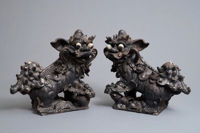 Two Chinese black-glazed roof tiles shaped as Buddhist lions, 19th C.