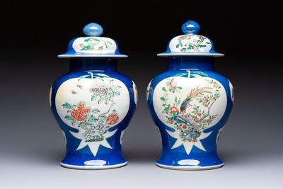 Two Chinese famille verte blue-ground vases and covers, 19th C.