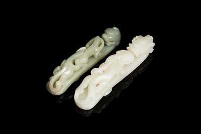 Two Chinese white and celadon jade belt hooks, Qing