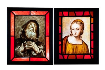 Two composite stained and painted glass windows with a monk and a female bust after Raphaël, 19th C.