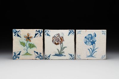 Two polychrome and one blue and white Dutch Delft 'flower' tiles, 17th C.