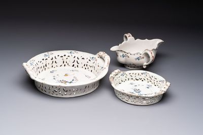 Two reticulated Brussels faience 'A la Haie Fleurie' baskets and a sauce boat, 18th C.