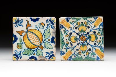 Two small polychrome Dutch Delft 'pomegranates' and 'tulips' tiles, ca. 1600