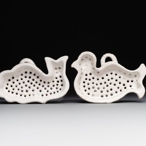 Two white-glazed pottery strainers in the shape of a dove and a whale, France, 18th C. — photo 1