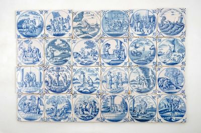 Un lot de 24 carreaux religieux en faïence de Delft bleu et blanc, 18ème