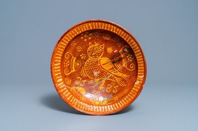 Un plat en terre cuite à décor d'un hibou, Pays-Bas du Nord, daté 1585