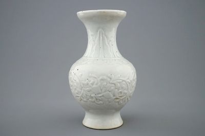Un vase en porcelaine blanc de Chine à décor floral moulé, Kangxi