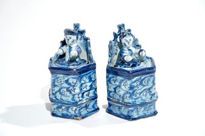 Une paire de figures d'enfants assis en faïence de Delft bleu et blanc, 18ème