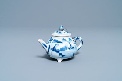 Une théière tripode en porcelaine de Chine en bleu et blanc à décor de figures dans un paysage, Kangxi