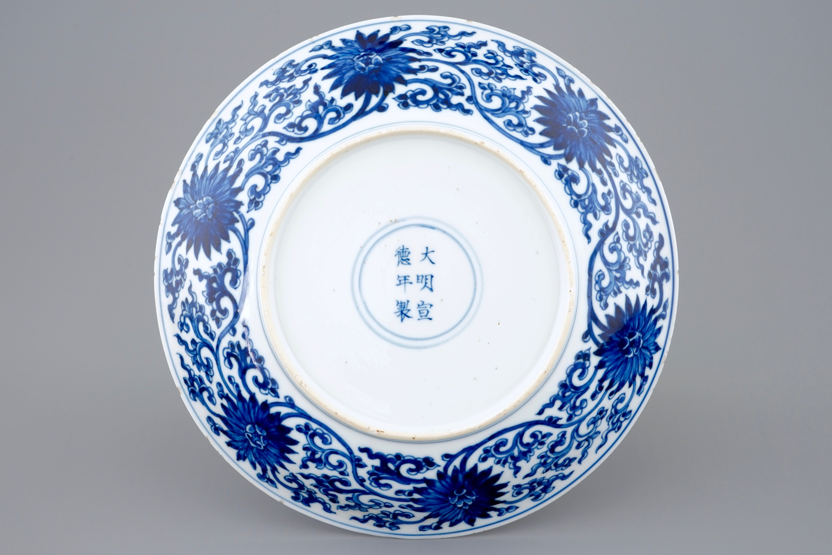 A Chinese blue and white lotus scroll plate, Xuande mark, Kangxi - Rob ...