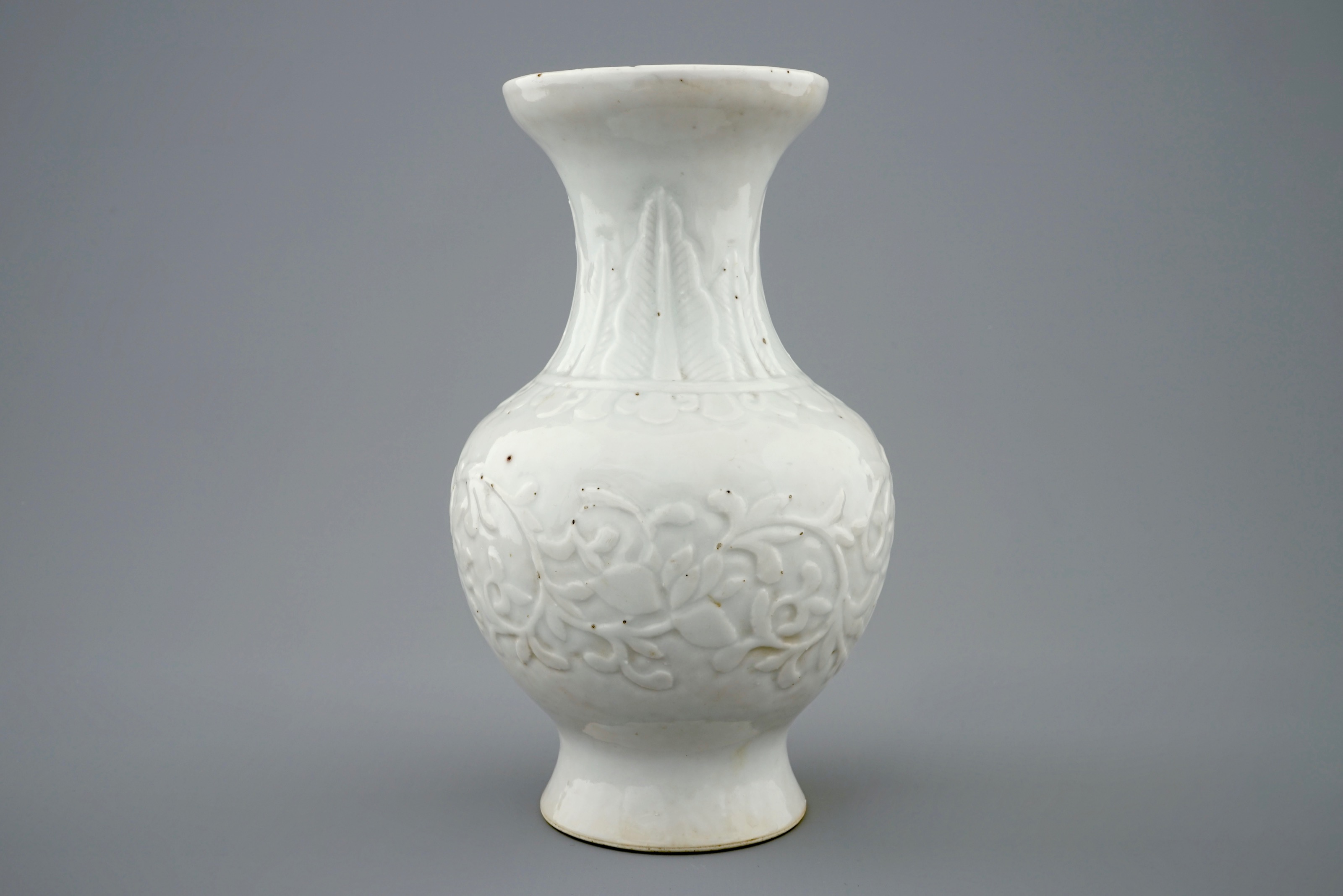 A relief-moulded blanc de Chine vase with flower scrolls, Kangxi - Rob ...