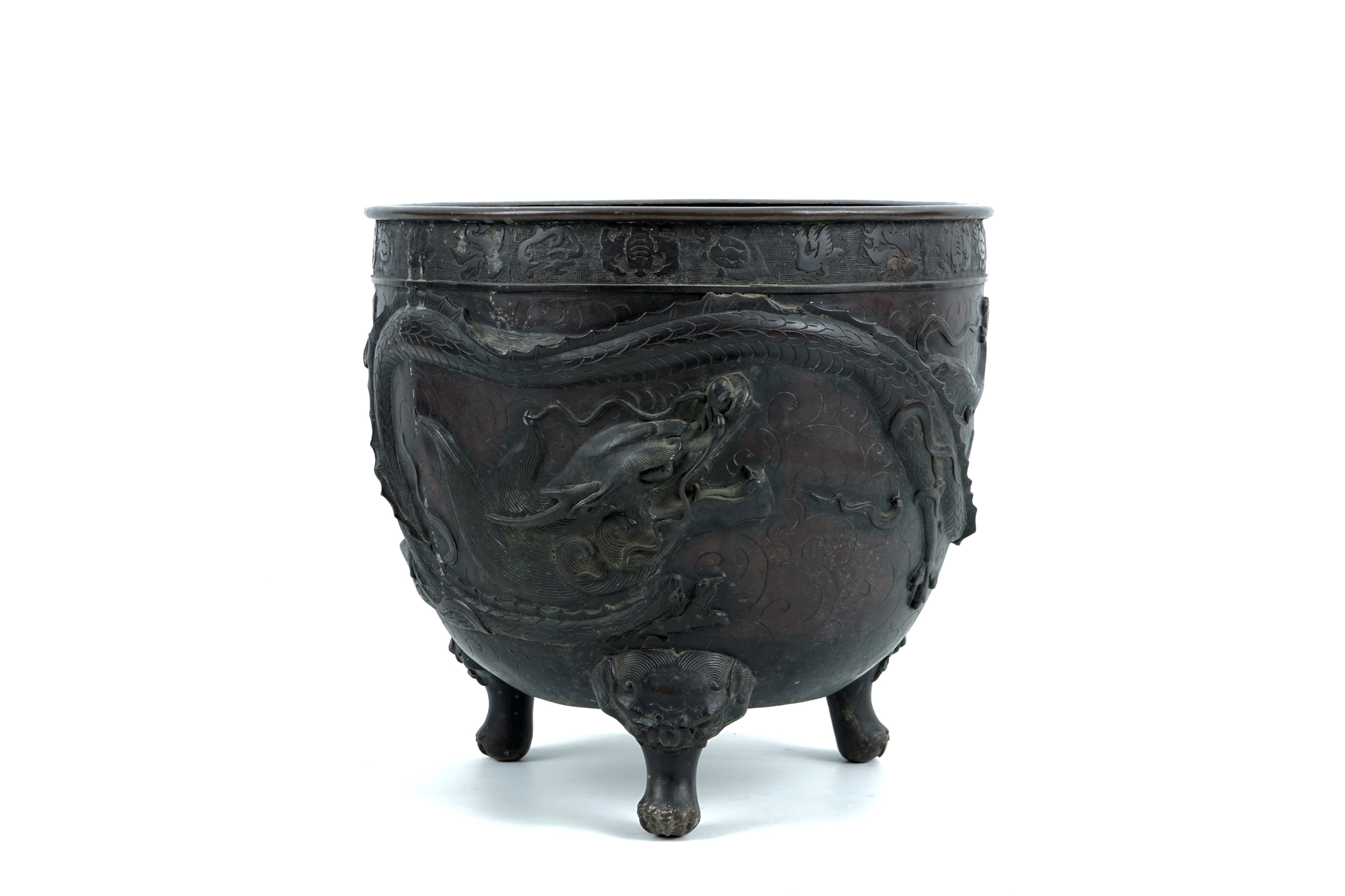 A large Japanese bronze relief-decorated jardiniere with a dragon and ...